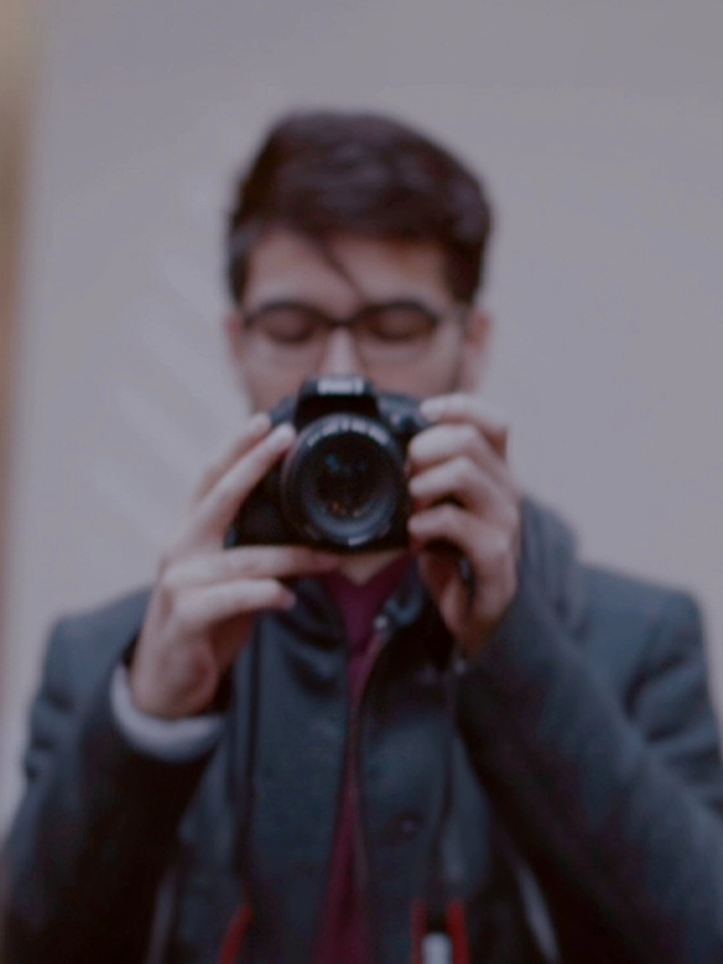 Person with a dog outdoors in a natural setting with plants and rocks